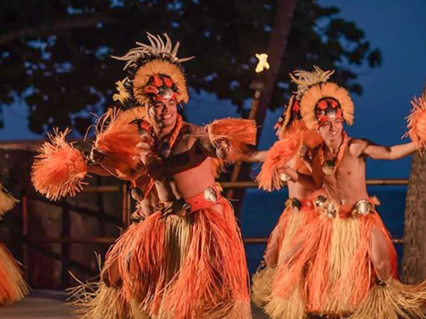 Traditional male Hawaiian hula dancers performing in authentic costumes during a cultural event